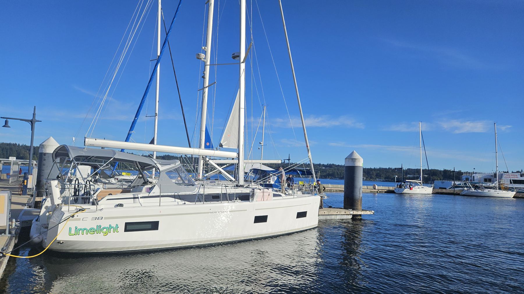 Limelight, a Bavaria C38, alongside the dock under a clear sky